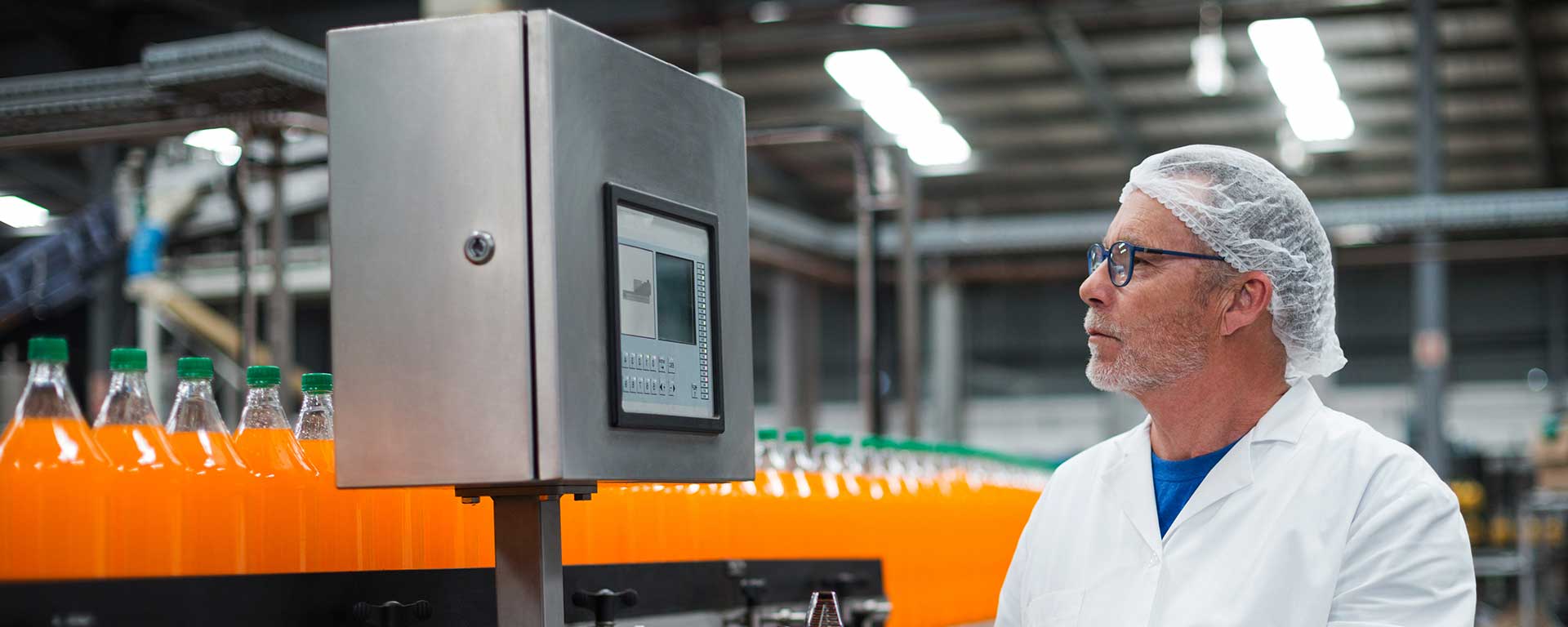 Worker watching bottling line