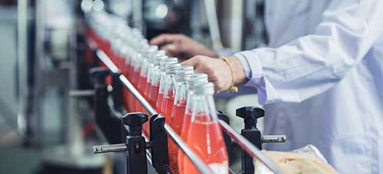 Glass beverage bottles coming down a production line