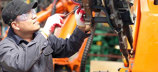 A man fixing industrial machinery