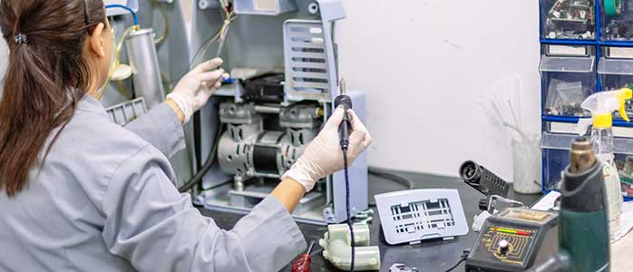 A woman working on electronics