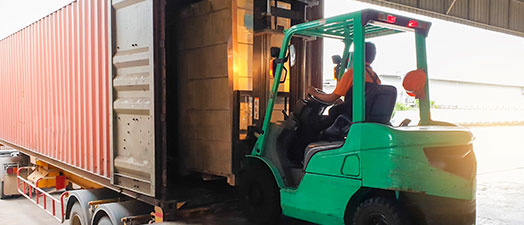 A forklift loading a trailer