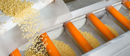 Macaroni being transferred between conveyer belts