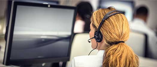 A woman looking at her computer at work