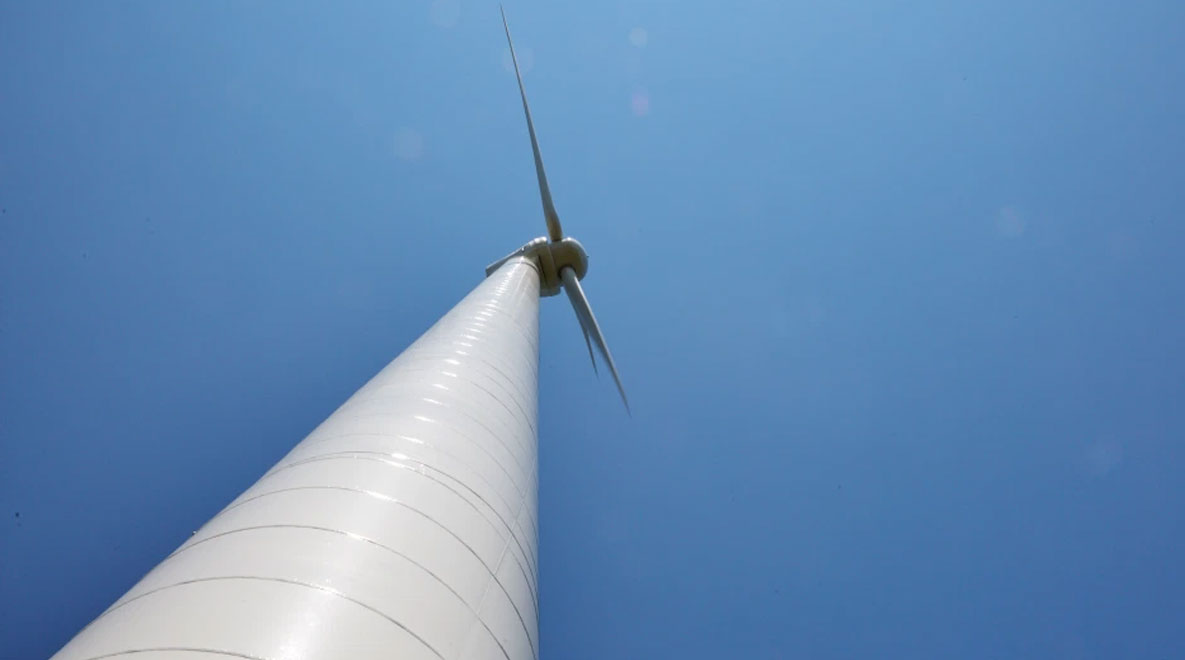 A shot of a wind turbine looking from near the bottom to the top.