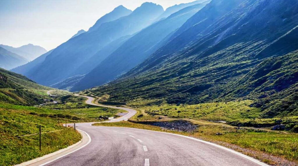A road in the bottom of a mountain valley.