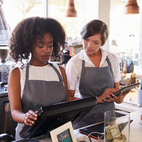 A retail employee training another.