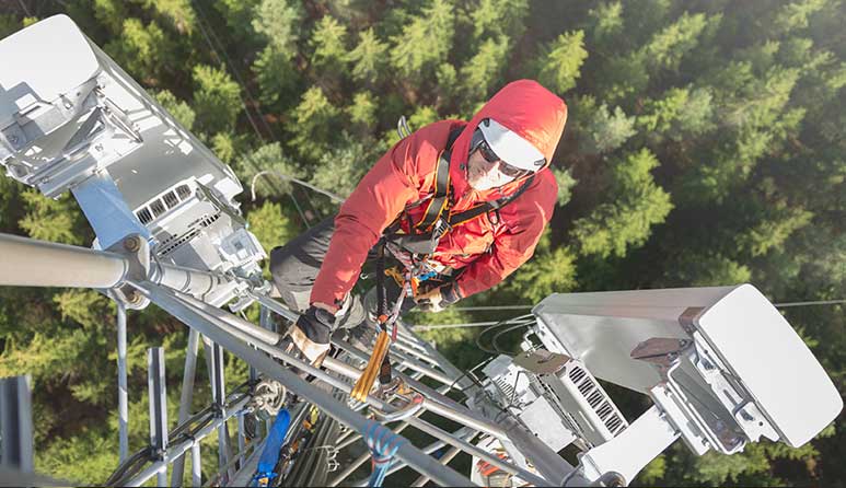 A man climbing a cell service tower.