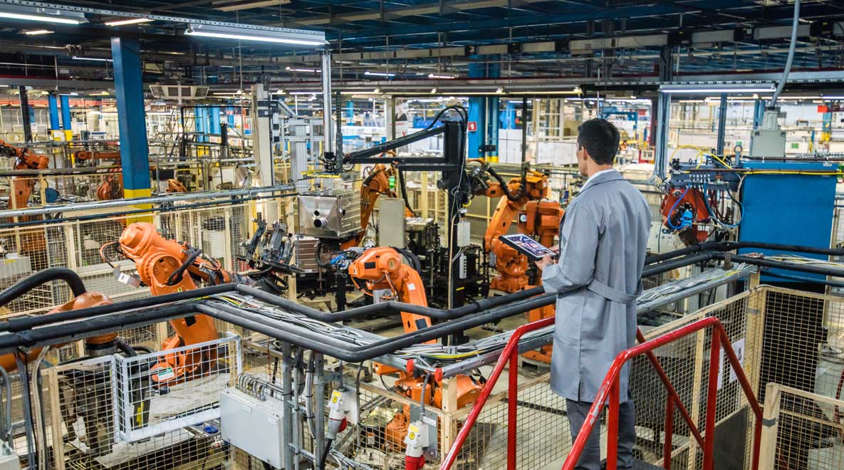 A man overlooking a production line.