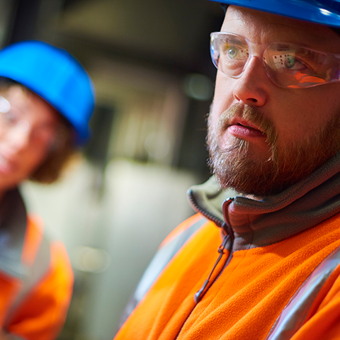 Two employees in hard hats.