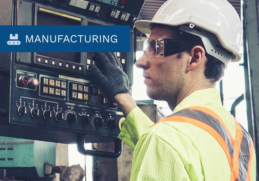 A manufacturing employee working equipment.